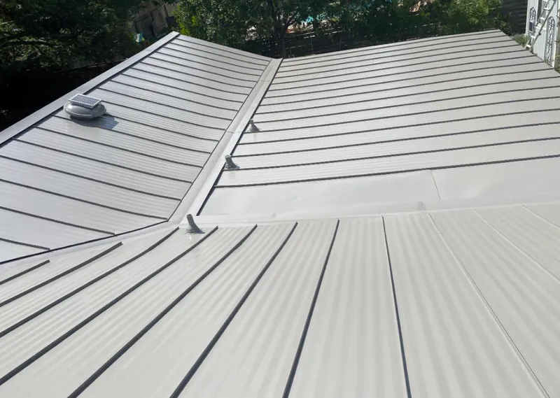 Solar attic fan installed on a metal roof for Roof Ventilation in Hampshire